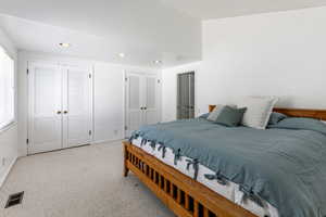 Bedroom featuring two closets  and built-in drawers