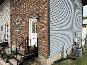 View of property exterior featuring cooling unit