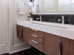 Bathroom with tile floors, backsplash, and vanity