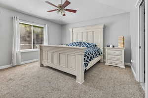 Bedroom with light colored carpet and ceiling fan