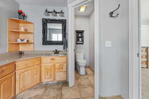 Bathroom with tile flooring, toilet, and vanity