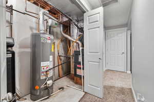 Utility room featuring gas water heater