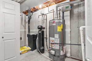 Utility room featuring gas water heater