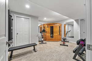 Workout area with a textured ceiling and carpet floors