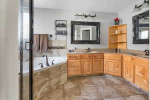 Bathroom featuring tile floors, dual bowl vanity, a healthy amount of sunlight, and shower with separate bathtub