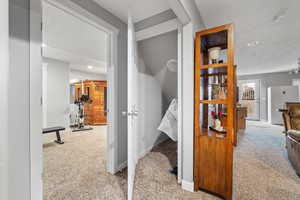 Staircase featuring a textured ceiling and carpet floors