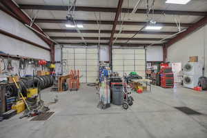 Garage featuring stacked washer and clothes dryer