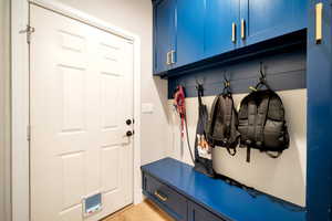 Custom Cabinetry Mudroom featuring light hardwood / wood-style flooring