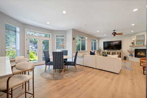 Dining space with ceiling fan and light hardwood / wood-style floors