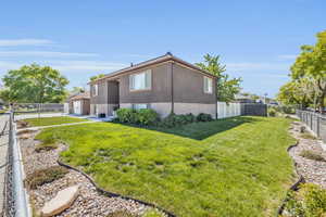 View of side of property with a lawn