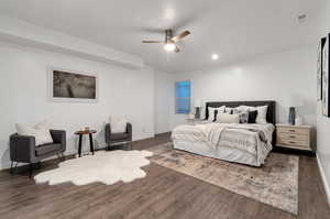 Bedroom with ceiling fan and dark hardwood / wood-style flooring