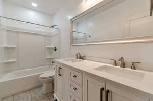 Full bathroom featuring shower / tub combination, tile flooring, toilet, and dual bowl vanity