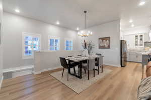 Dining room featuring light hardwood / wood-style flooring and a chandelier