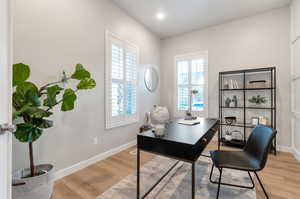 Office space featuring light hardwood / wood-style floors