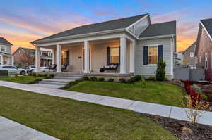 View of front of house with a lawn and a porch