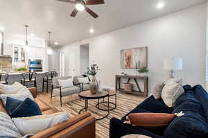 Living room with ceiling fan and light hardwood / wood-style flooring