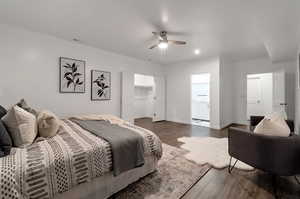 Bedroom featuring a spacious closet, a closet, ceiling fan, and dark hardwood / wood-style flooring