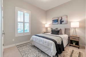 Bedroom featuring carpet flooring and multiple windows