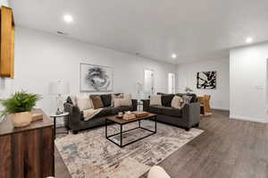 Living room with wood-type flooring