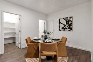 Dining area with dark wood-type flooring