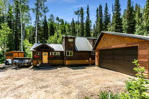 View of front of home featuring an outdoor structure and a garage