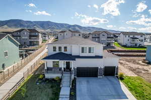 View of front facade featuring a garage and a mountain view