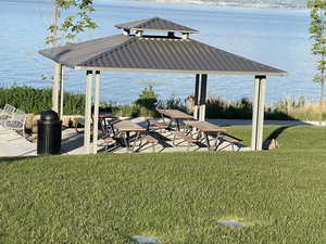 View of yard with a water view and a gazebo