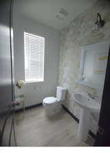 Bathroom featuring hardwood / wood-style flooring and toilet