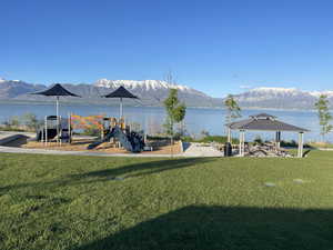 View of yard featuring a playground, a gazebo, and a water and mountain view