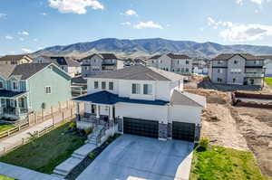 View of front of property featuring a garage and a mountain view