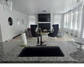 Living room featuring sink and light hardwood / wood-style floors