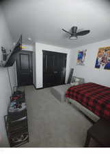 Carpeted bedroom with ceiling fan