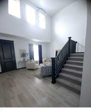 Interior space featuring a high ceiling and hardwood / wood-style flooring