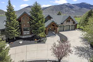 View of front of property with a garage and a mountain view