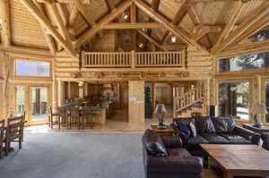 Tiled living room featuring beamed ceiling, high vaulted ceiling, wooden ceiling, and log walls