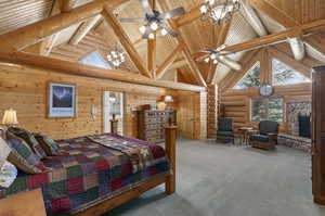 Primary bedroom featuring a stone fireplace, beam ceiling, wood ceiling, high vaulted ceiling, and log walls