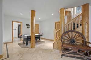 Interior space featuring light tile floors air hockey table