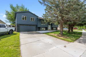 View of front of house featuring a garage and a front lawn