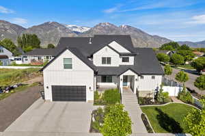 Modern inspired farmhouse featuring a garage and a mountain view