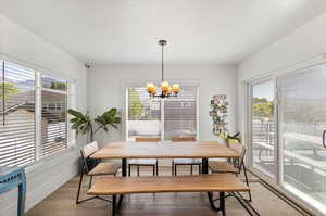 Dining room with hardwood / wood-style flooring and a chandelier