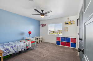 Carpeted bedroom with ceiling fan