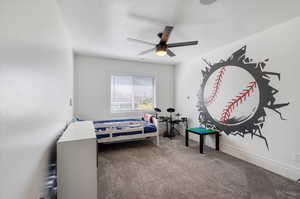 Carpeted bedroom with ceiling fan and a textured ceiling