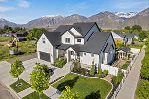 View of front of house with a garage and a mountain view