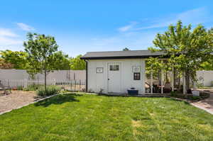 View of shed / structure featuring a yard