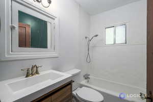 Full bathroom featuring vanity, shower / bath combination, and toilet