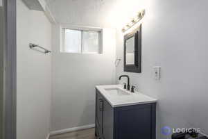 Bathroom featuring hardwood / wood-style flooring and vanity