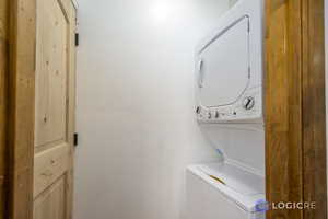 Laundry room featuring stacked washer / drying machine