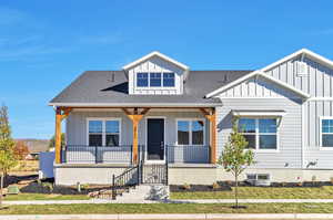 View of front facade featuring a front lawn and a porch