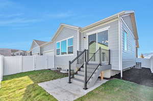 View of front of property with central AC and a front lawn