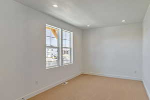 Spare room featuring carpet floors and a textured ceiling